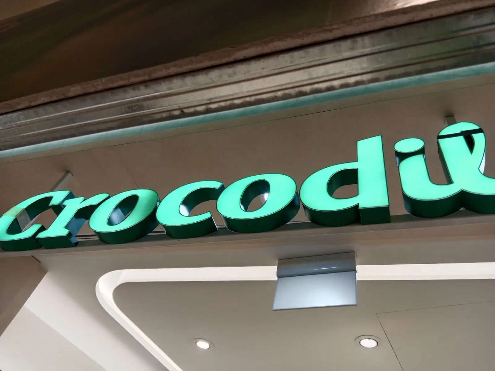 Close-up of custom illuminated Crocodile retail signage