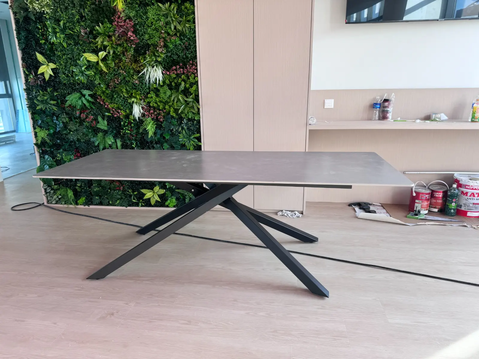 Contemporary conference table installed beside a green feature wall