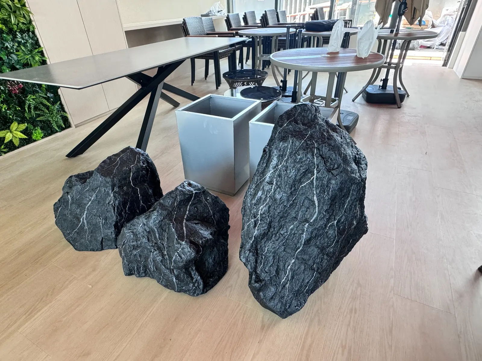 Sculptural stone-effect planters beside an office collaboration table
