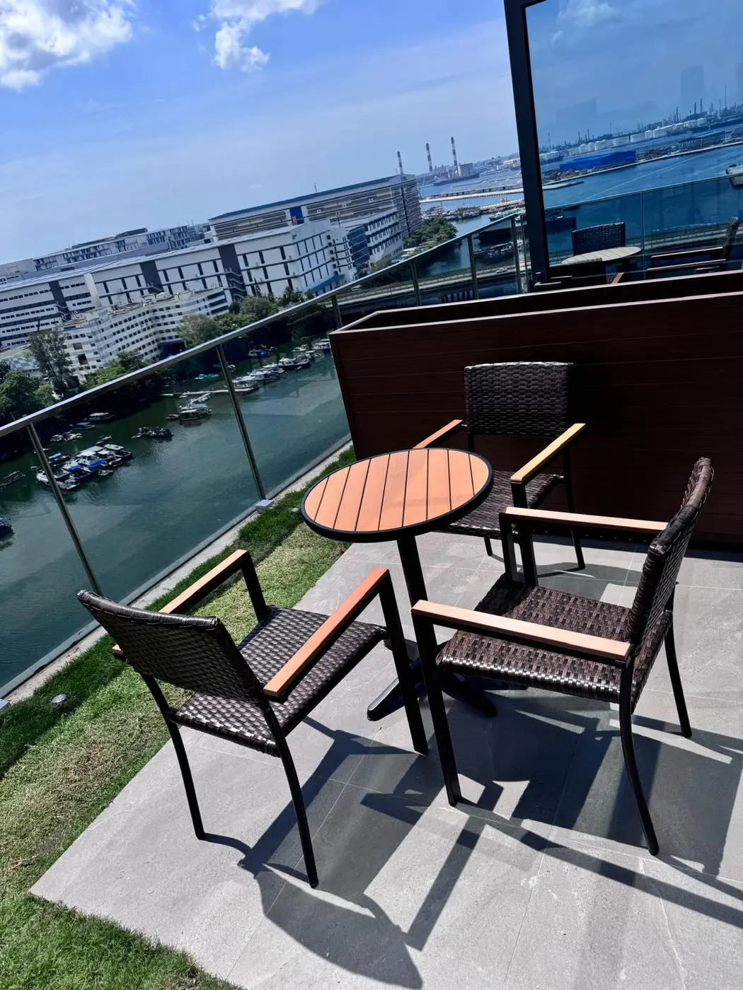 Outdoor table and chairs on a waterfront balcony