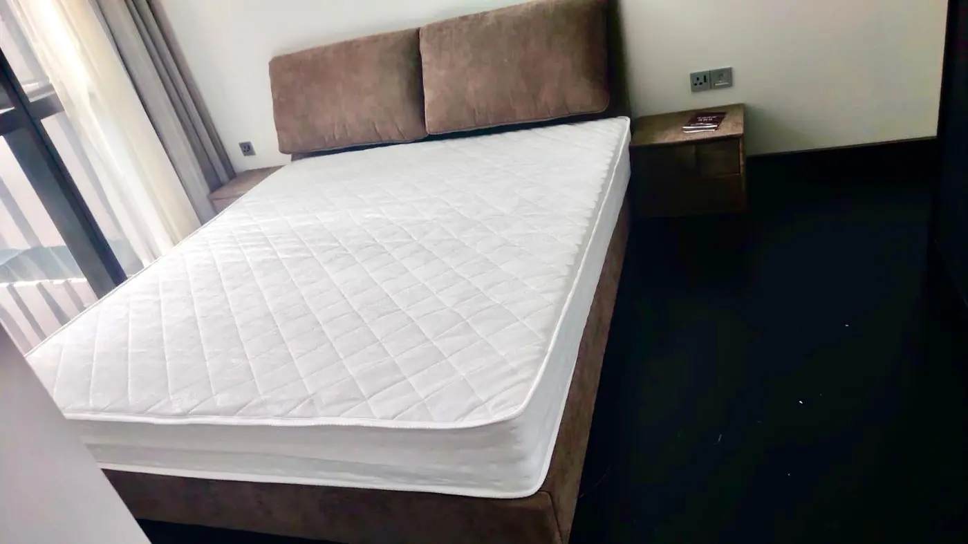 Upholstered bed and mattress installed in a completed bedroom