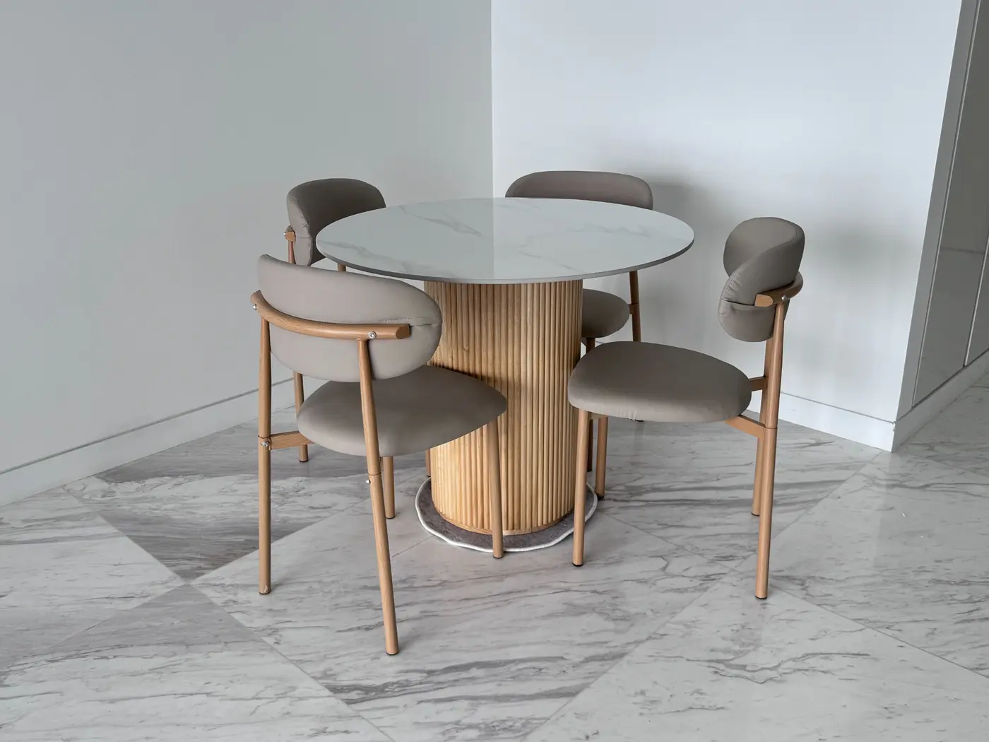 Round marble-effect dining table with four upholstered timber chairs