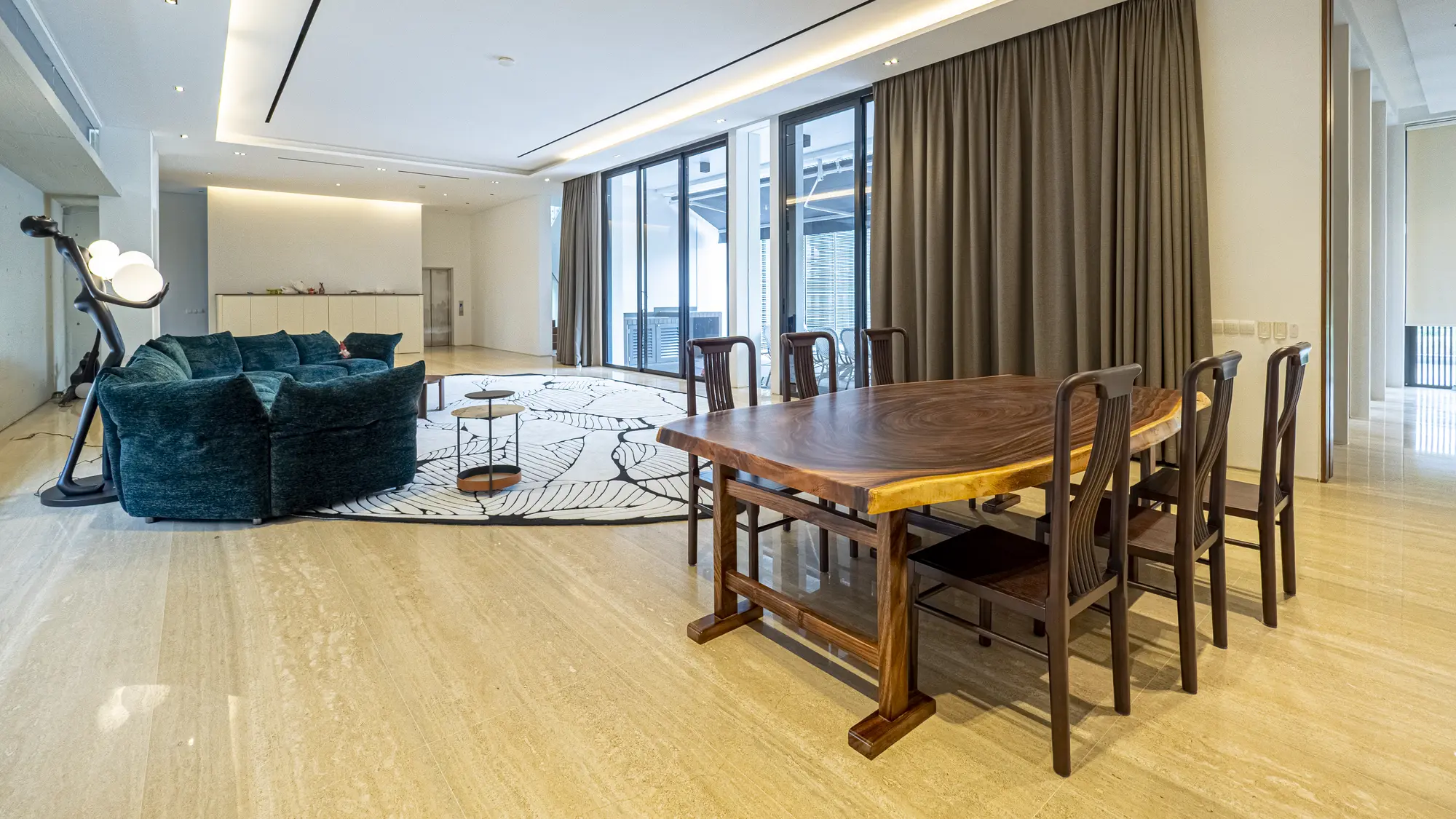 Wide view of the open living and dining room furnished by Homejoy