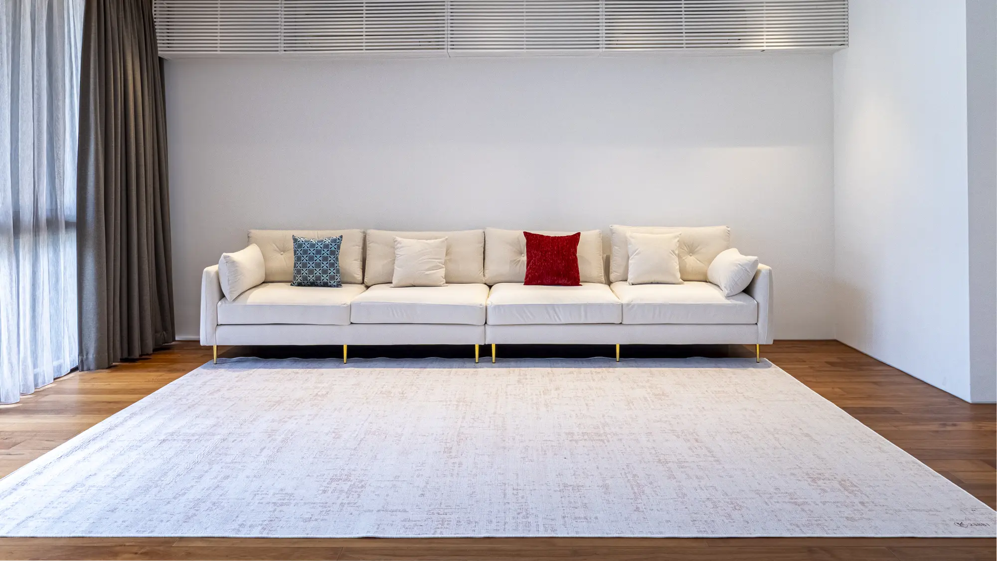 Bright sitting room with a long white sofa