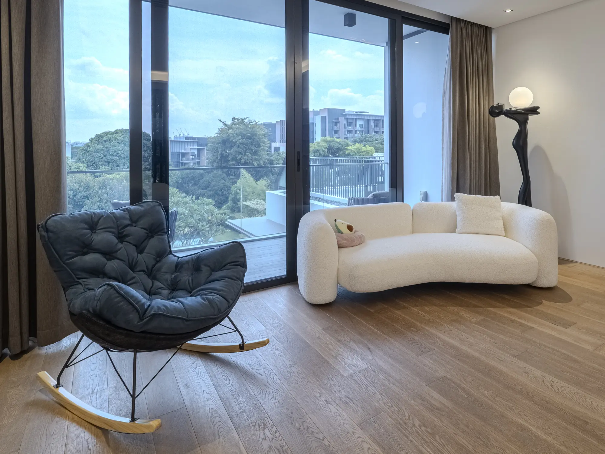Window reading area with curved sofa and lounge chair